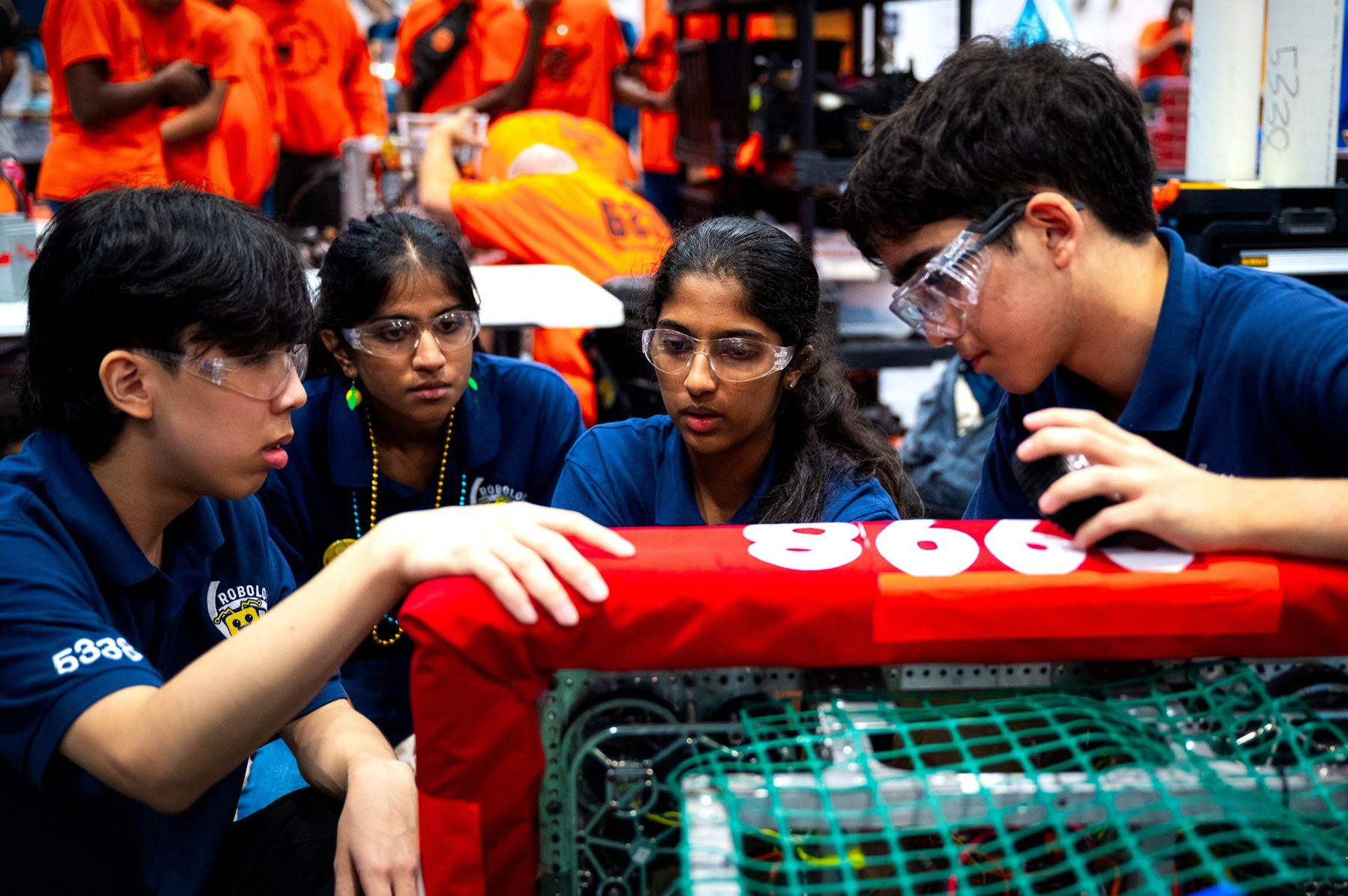 Robotics team examining robot